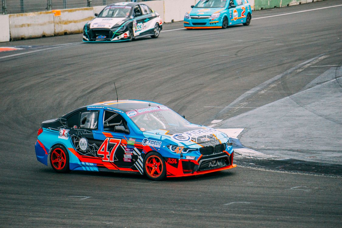 Car Track Racer Cars Racing on a Track · Free Stock Photo