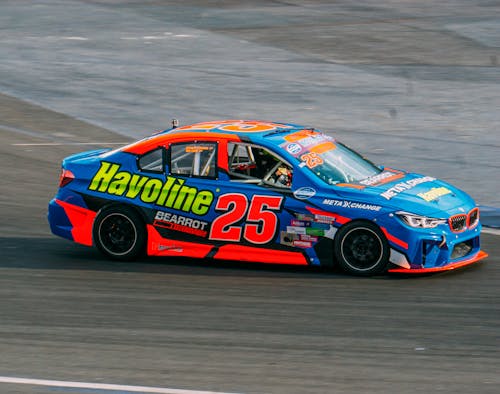 A car with the number 25 on it is driving on a track