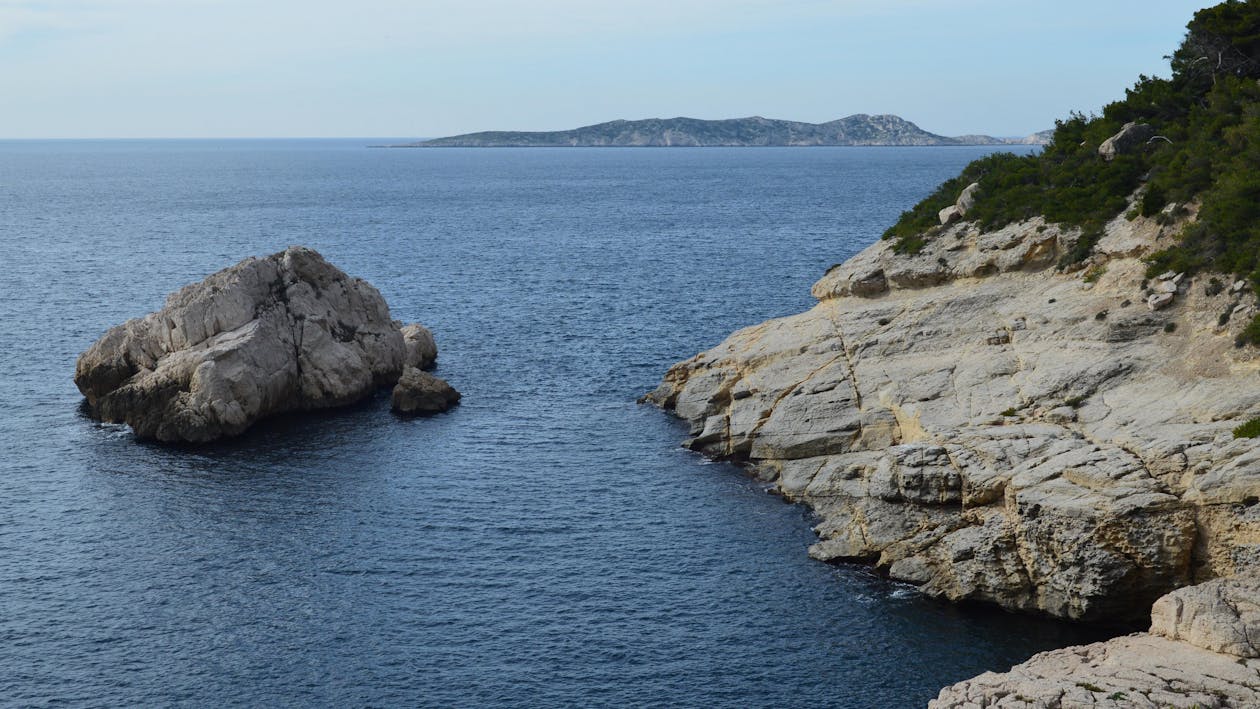 Rocks on Sea Shore with Island behind