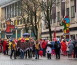 Vibrant street celebration during Cologne's famous carnival festival with attendees in colorful costumes and parade floats.