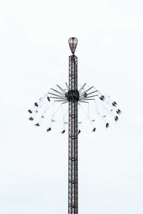 Free People enjoying a thrilling carousel ride high above the city, captivating and exhilarating experience. Stock Photo