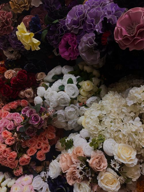 Free Vibrant floral display featuring roses, hydrangeas, and ruffled blossoms in various hues. Stock Photo