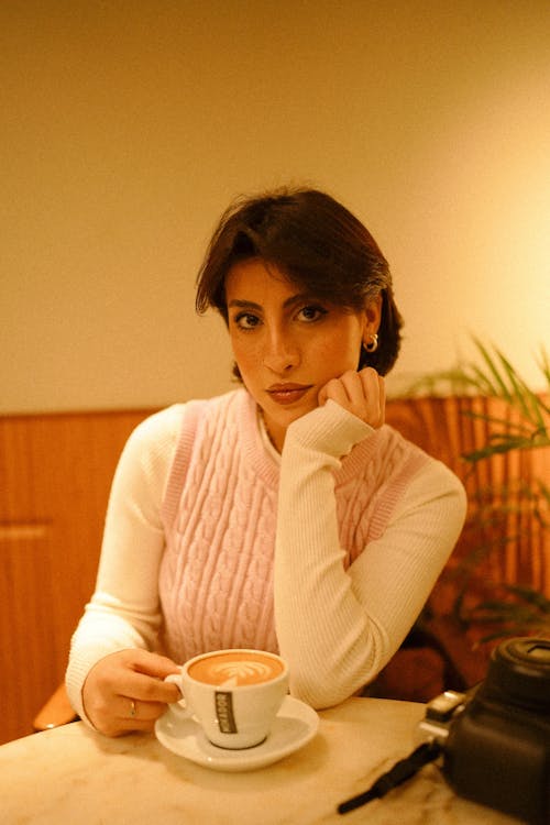Woman Drinking Coffee in a Restaurant