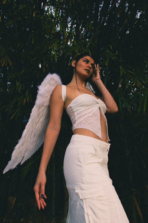 Model in Lace White Top and Skirt Wearing Angel Wings