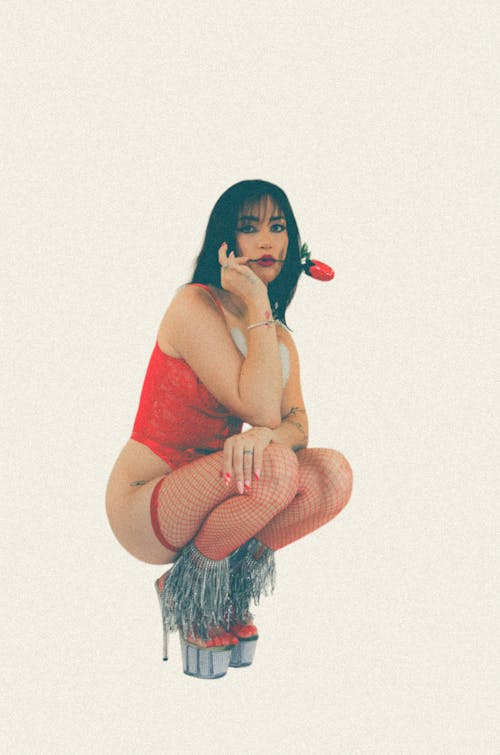 Woman Squatting in Red Bodysuit and with Flower