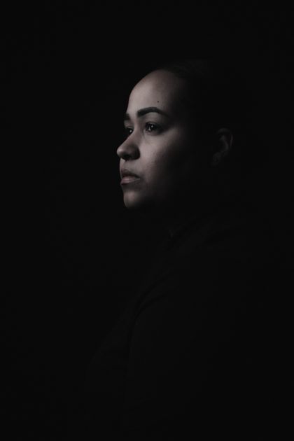 Moody low-light studio portrait of a woman — photo by Elisanette Ortiz on Pexels