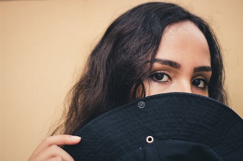 Woman Holding Black Hat