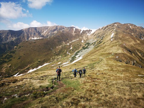 Man Hiking on Footpath in Mountains