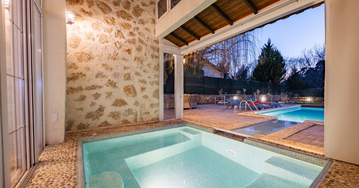 Elegant scene of a modern indoor-outdoor pool setting, perfect for relaxation.