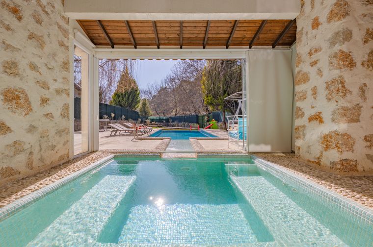 Swimming pool with a stone-paved surround at a luxury villa
