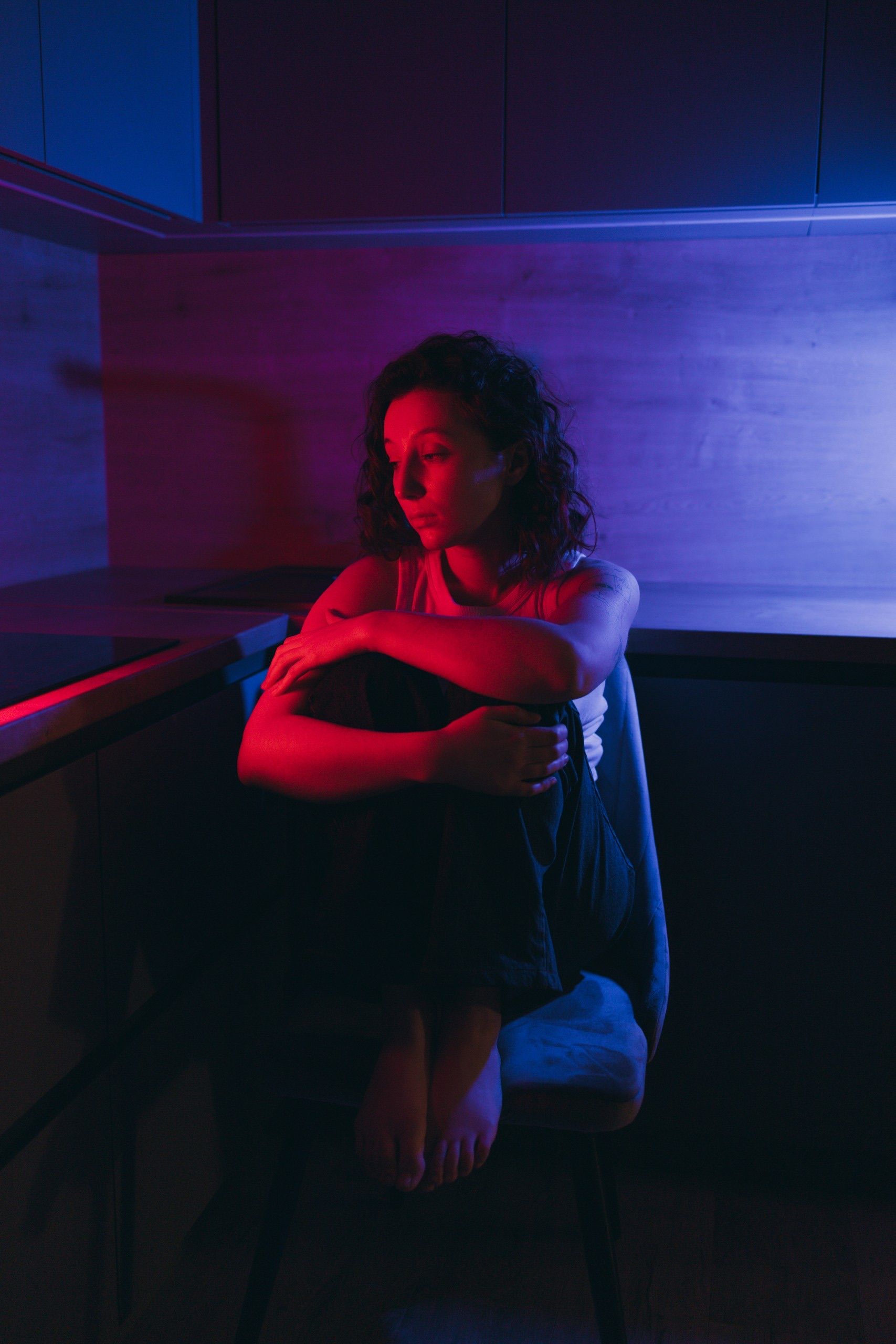 A Woman Sitting in a Dark Room · Free Stock Photo