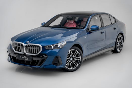 Sleek blue BMW i5 sports car showcased on a clean white background, highlighting its design.