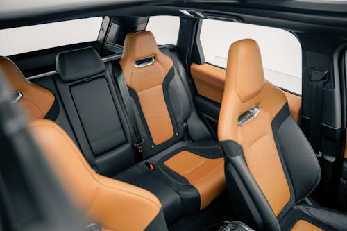 The interior of a car with orange leather seats