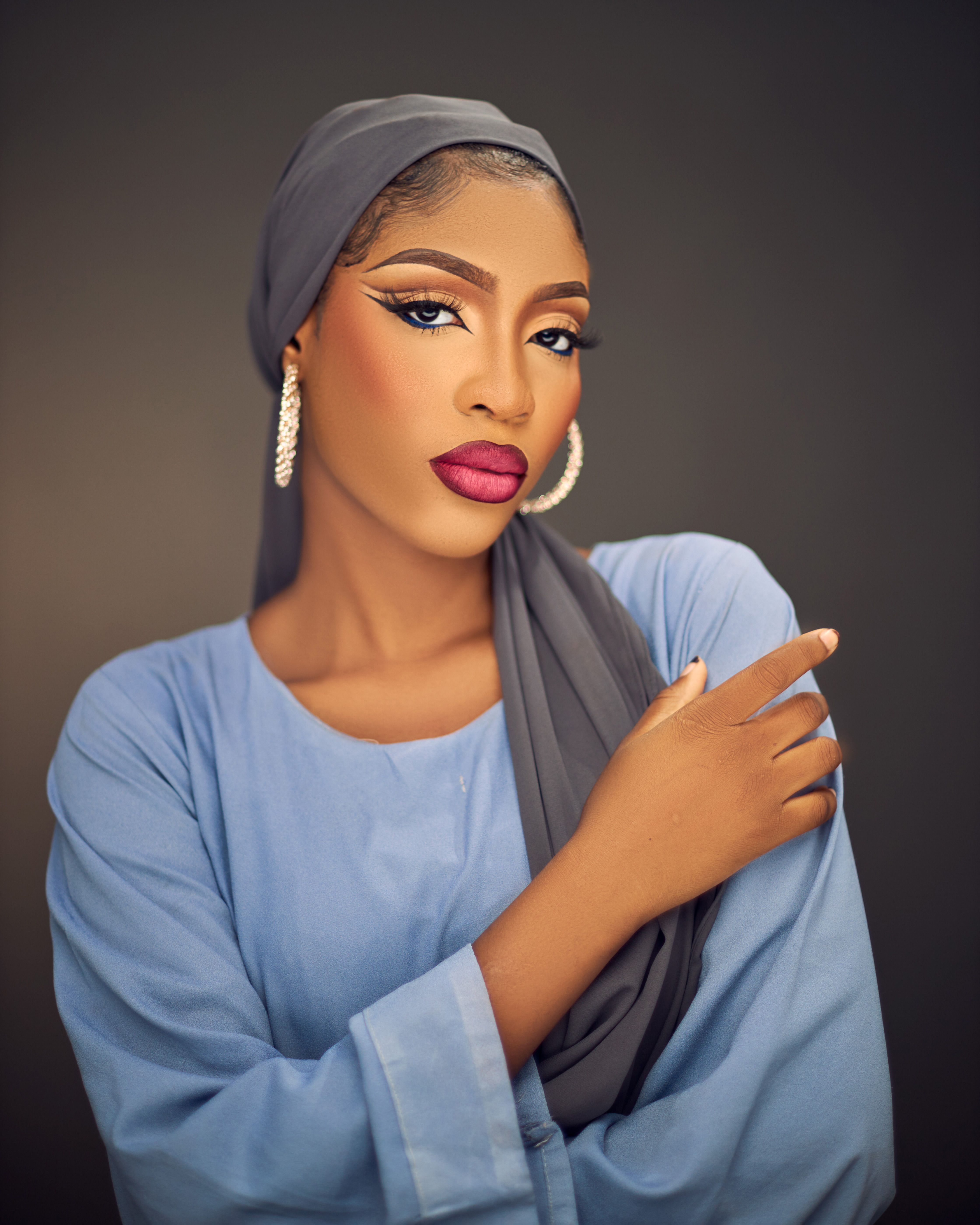 Striking studio portrait of a fashionable woman wearing a hijab, showcasing elegance and beauty.