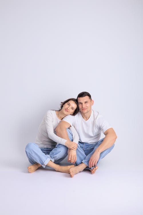 Couple Sitting and Hugging on White Background