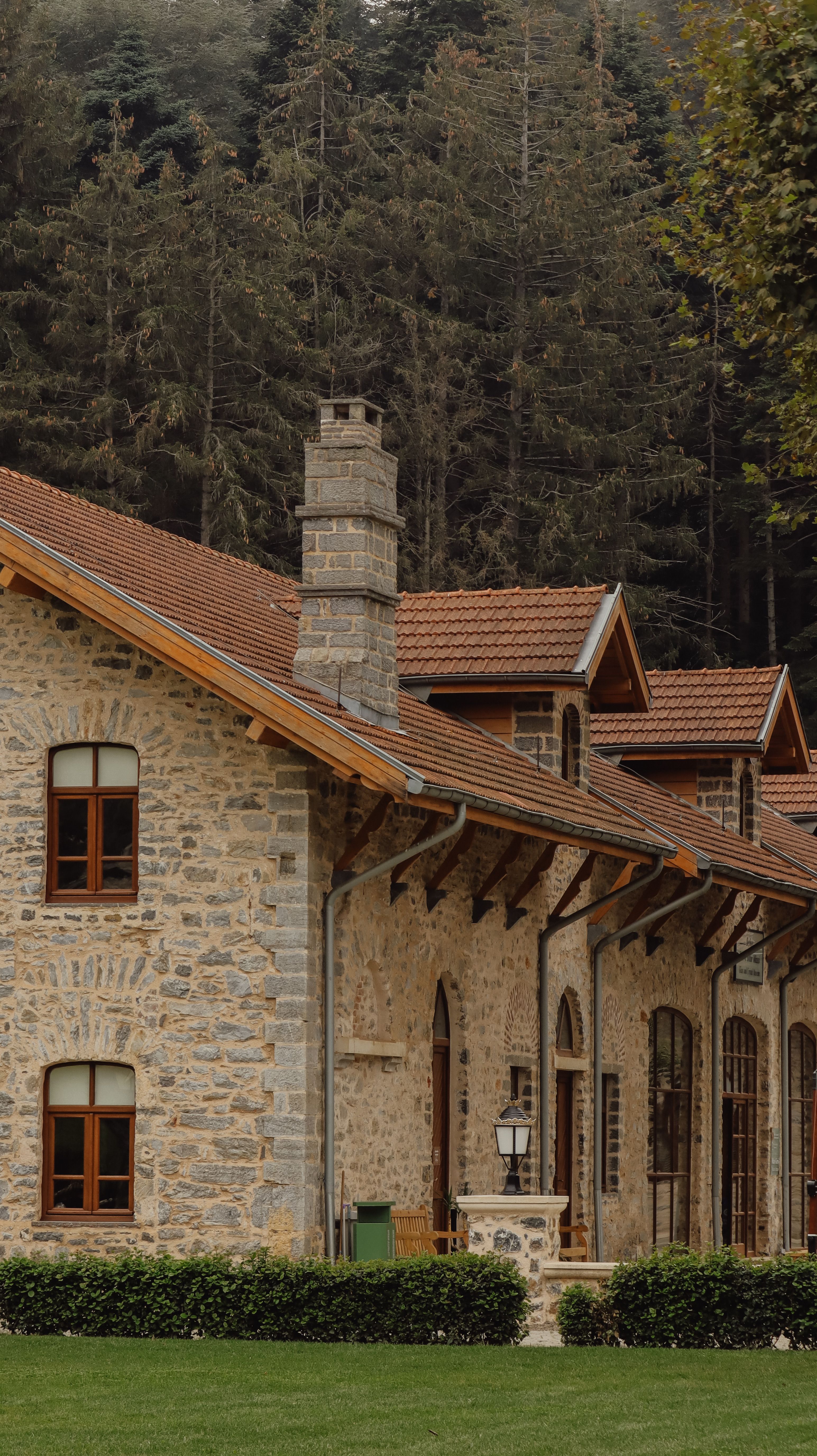 Charming stone house surrounded by lush forest, perfect for nature lovers.