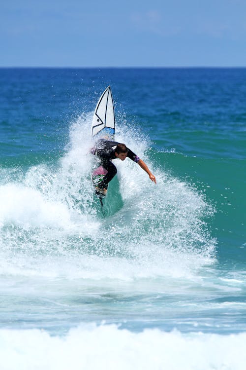 Surfer Surfing the Waves on the Sea 