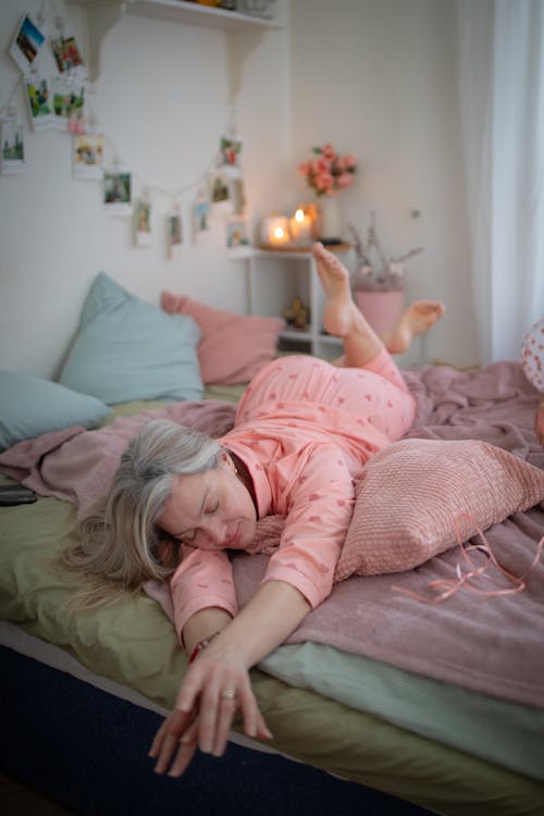 Free Blonde Woman in Pajama Lying Down on Bed Stock Photo