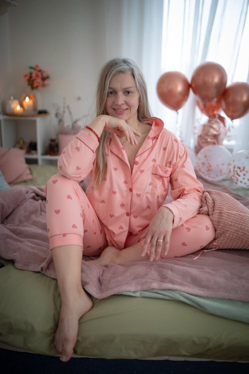 Smiling Woman Sitting on Bed
