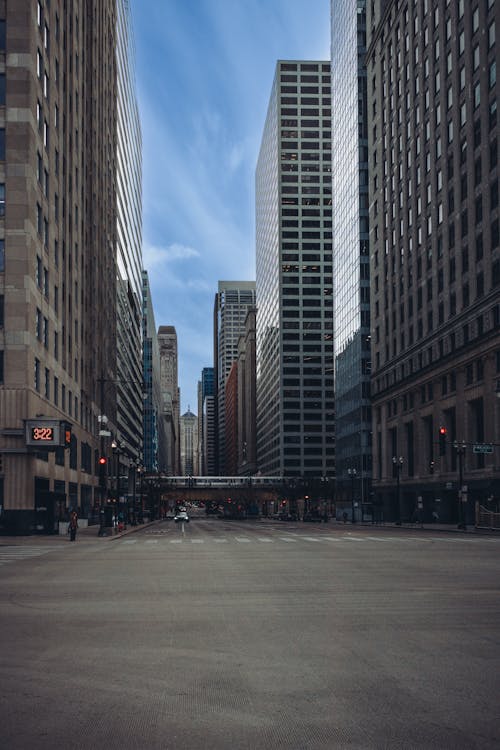 A city street with tall buildings and empty space