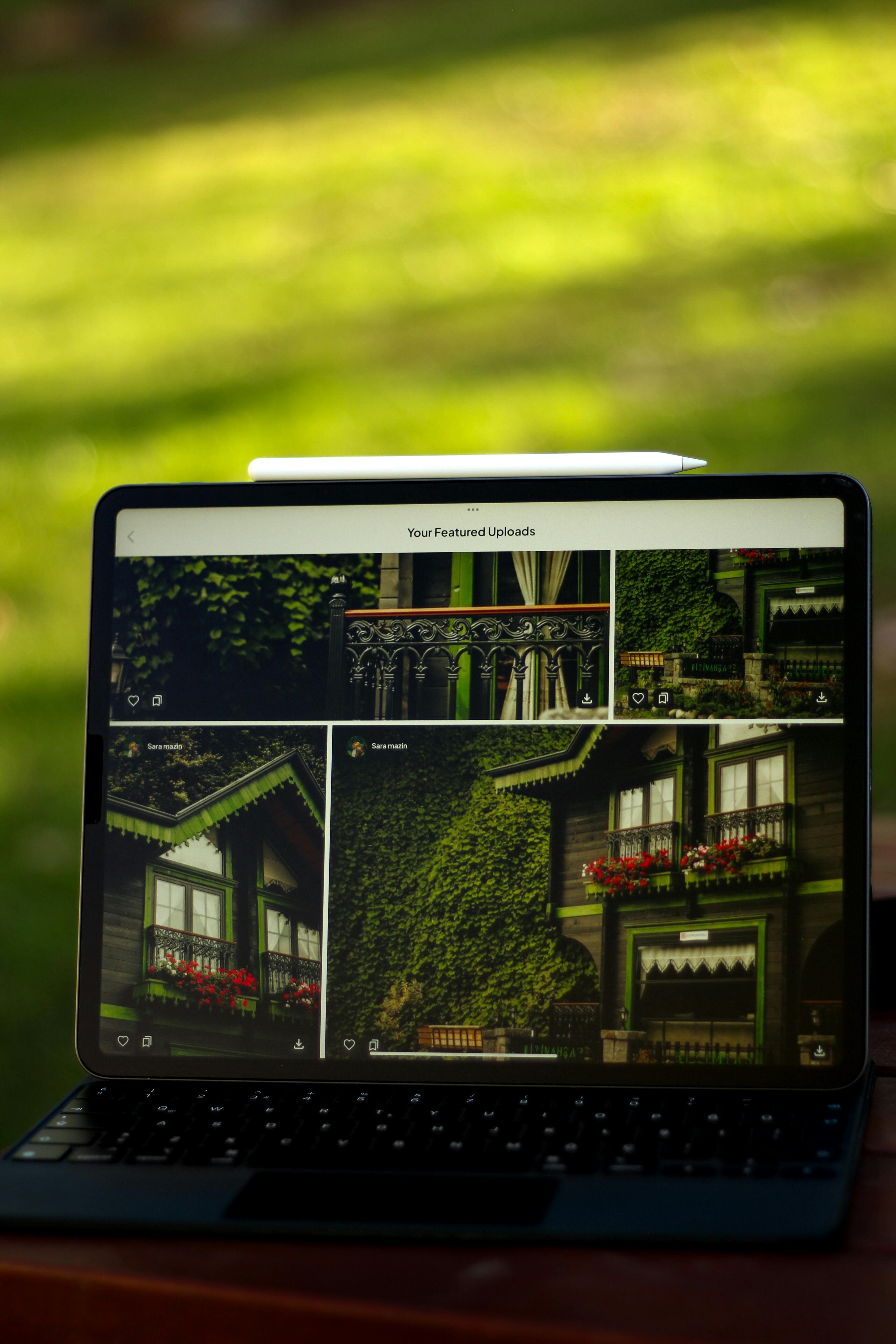 Tablet screen with images of an ivy-covered, green-framed house outdoors.