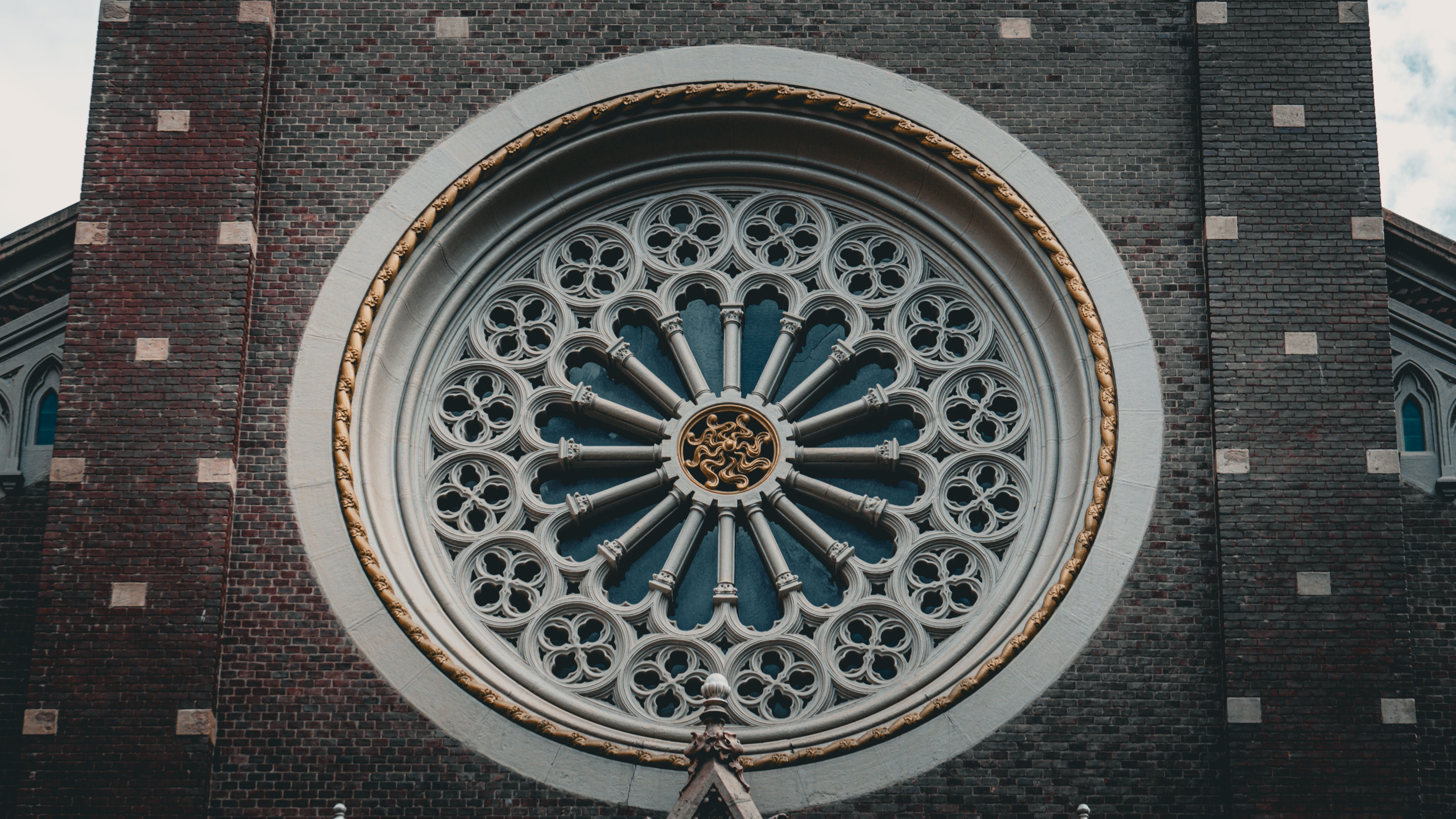 Close-up of a detailed rose window showcasing stunning Gothic architectural design.