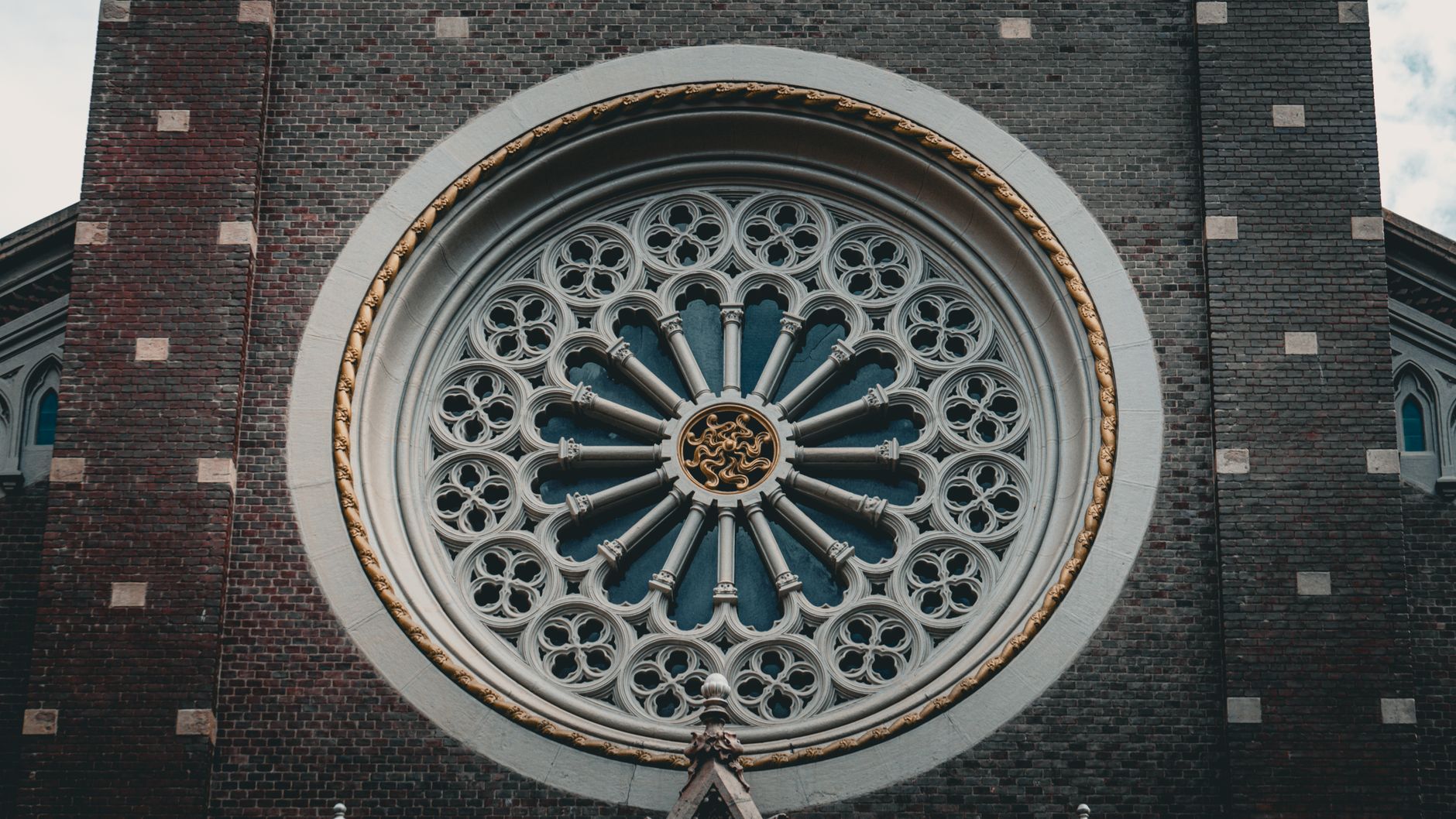 Close-up of a detailed rose window showcasing stunning Gothic architectural design.