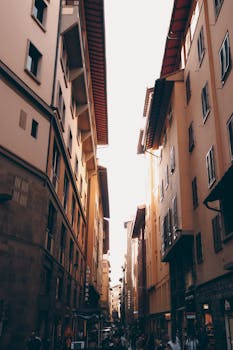 Charming narrow street in Florence, Tuscany, Italy with warm sunset tones and classic architecture.