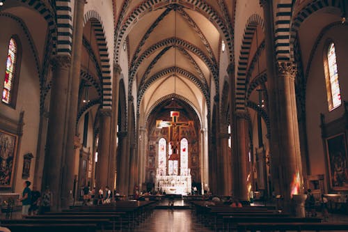 A cathedral with a large altar and arched windows