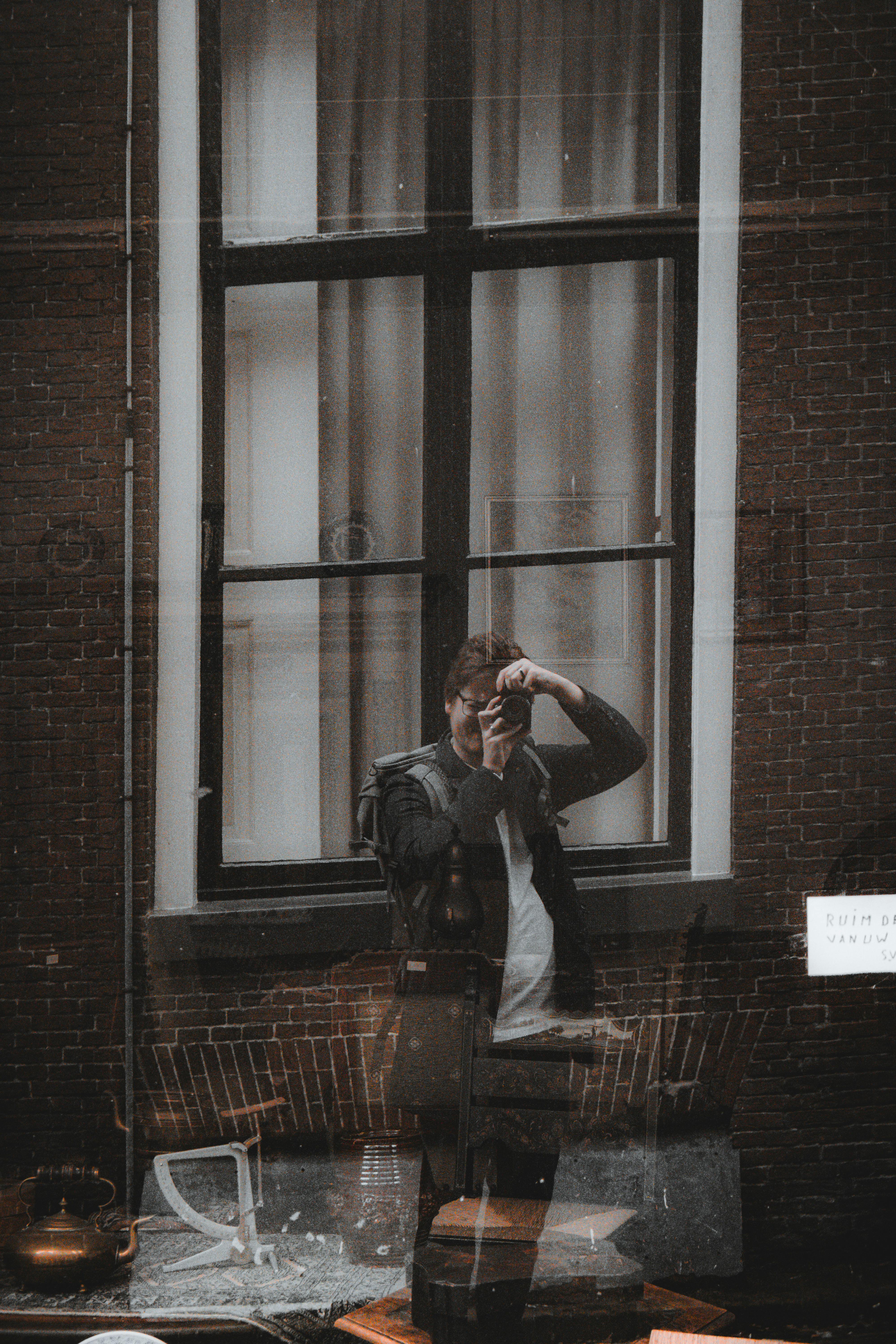 Photographer's self-portrait as reflection in a city window in Leeuwarden.