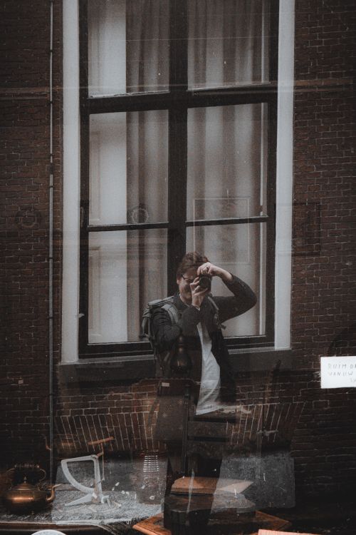 Free Photographer's self-portrait as reflection in a city window in Leeuwarden. Stock Photo