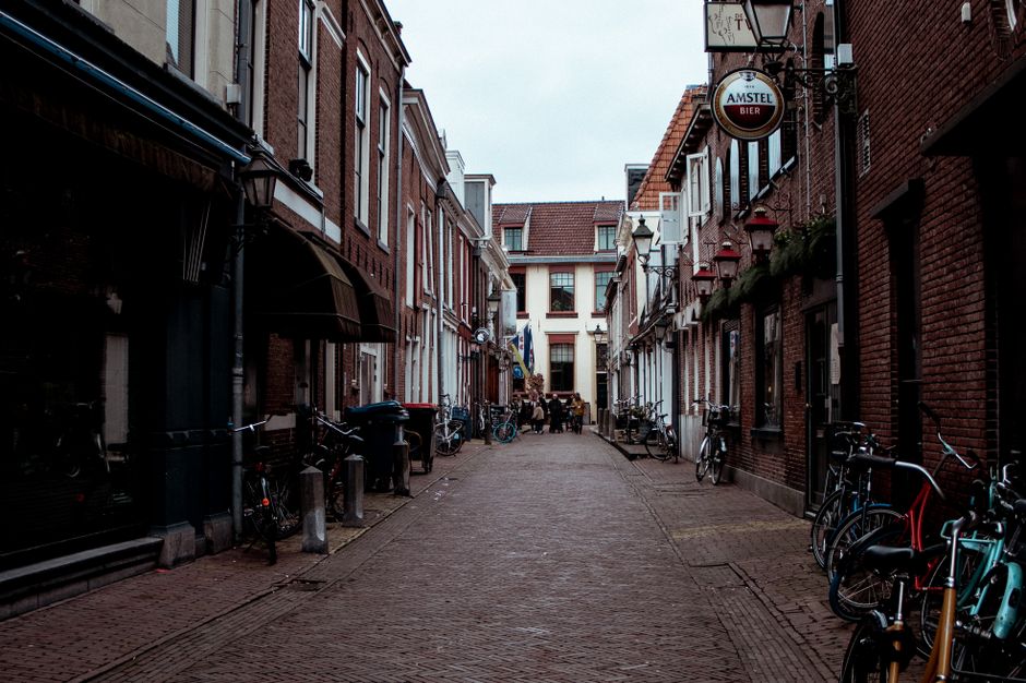 Picturesque street in Leeuwarden, Netherlands with bicycles and historic architecture.
