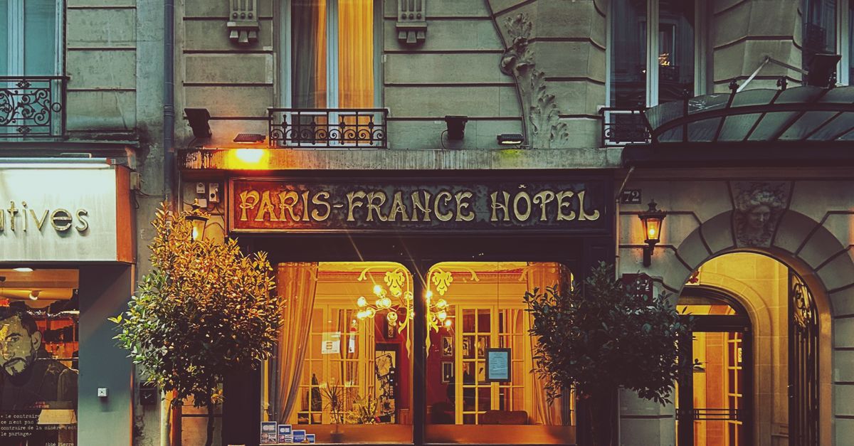 Atmospheric night view of a Paris hotel, highlighting classic architecture and city charm.
