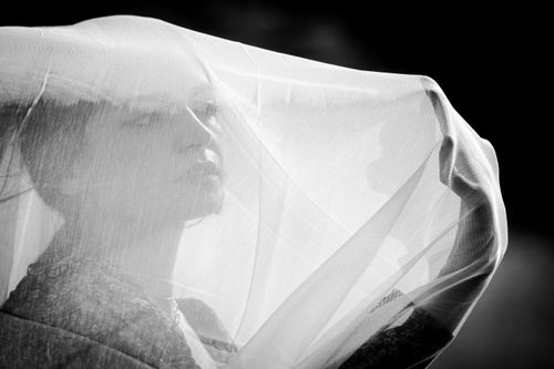 Free A mysterious black-and-white portrait of a woman with a sheer veil, evoking elegance and intrigue. Stock Photo