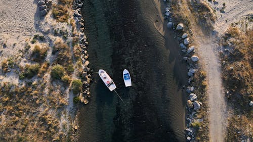 Boat and Motorboat on River on Desert