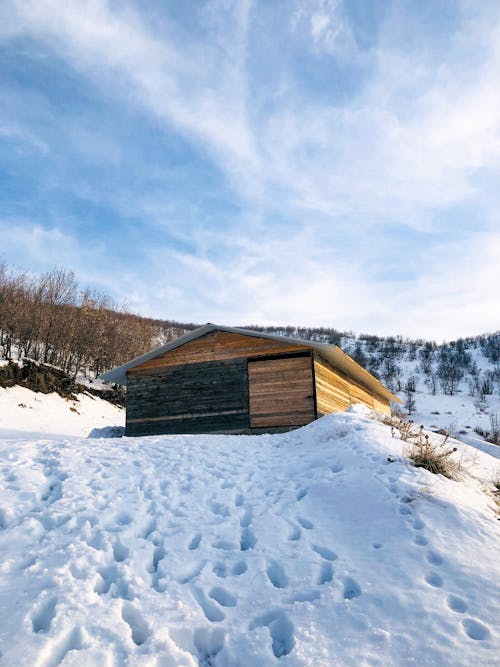 Wooden Building on Hill in Snow