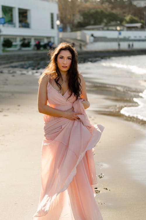 Model in Pink Dress on Sandy Beach