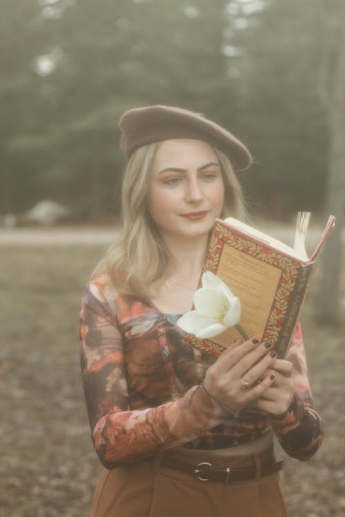 Blonde in Beret Posing with Book and Flower