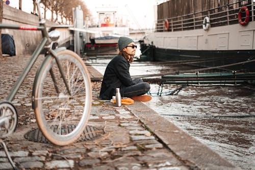 Man with Bike by the Stream