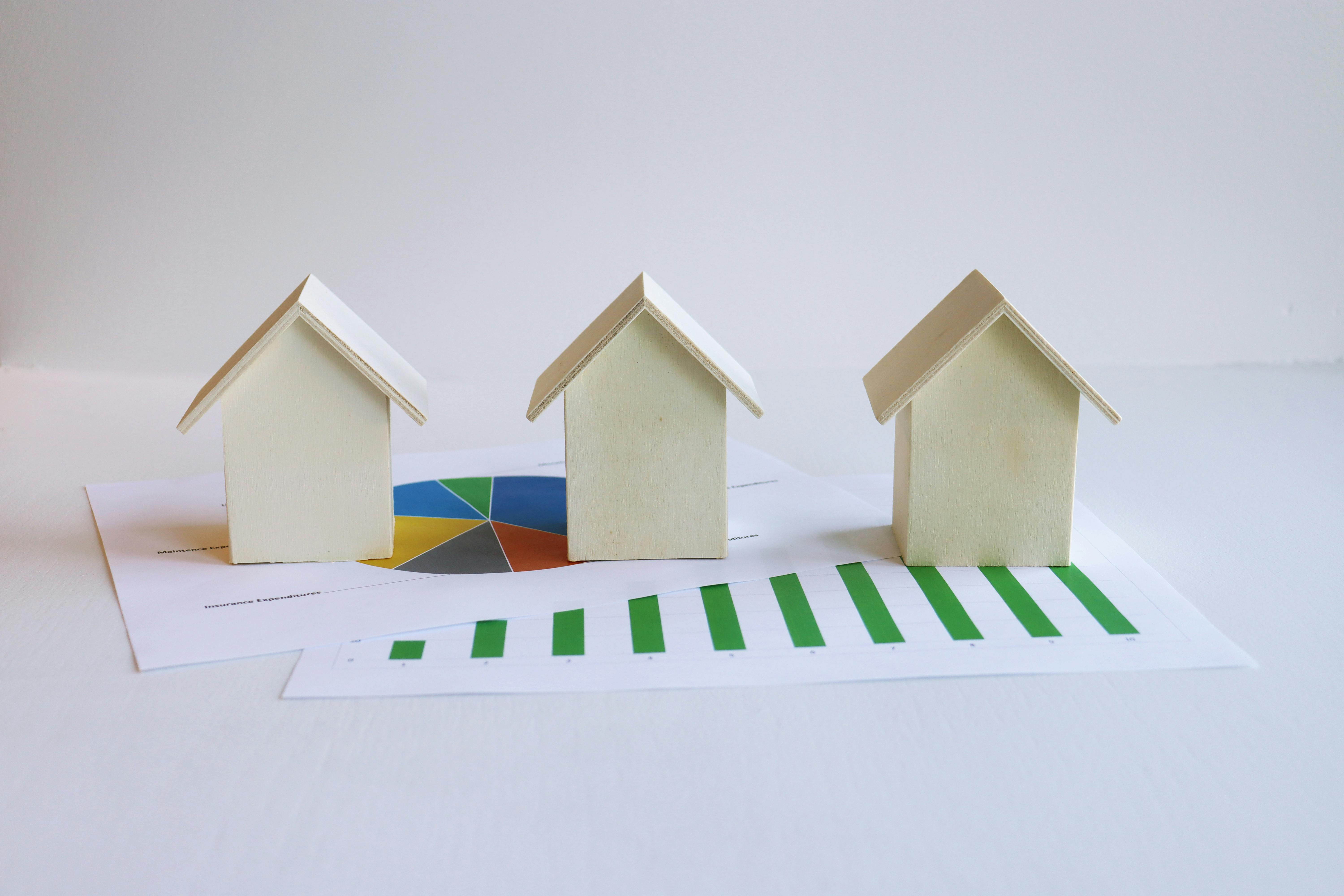 Free Wooden Model Houses and Printed Graphs Stock Photo