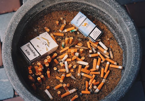 A pile of cigarettes and cigarettes in a bowl