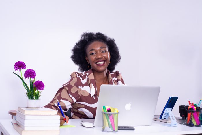 African businesswoman reviewing statutory filings at her desk