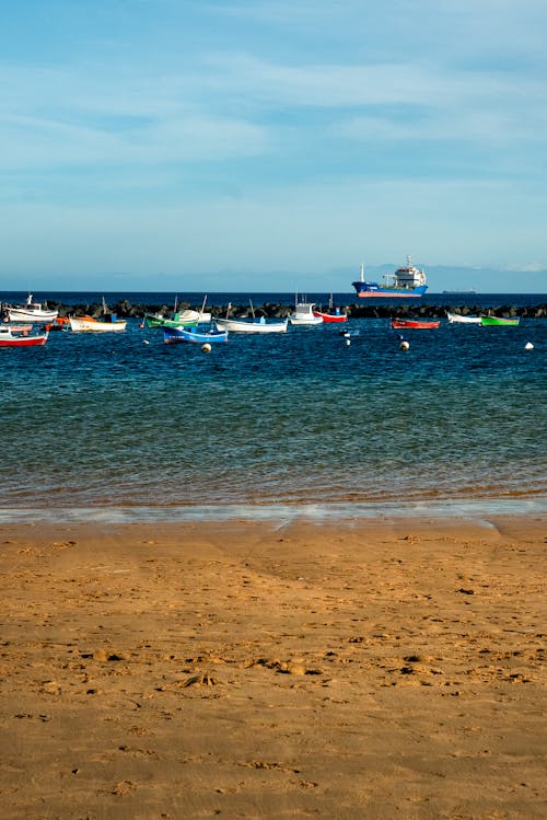 A beach with boats in the water
