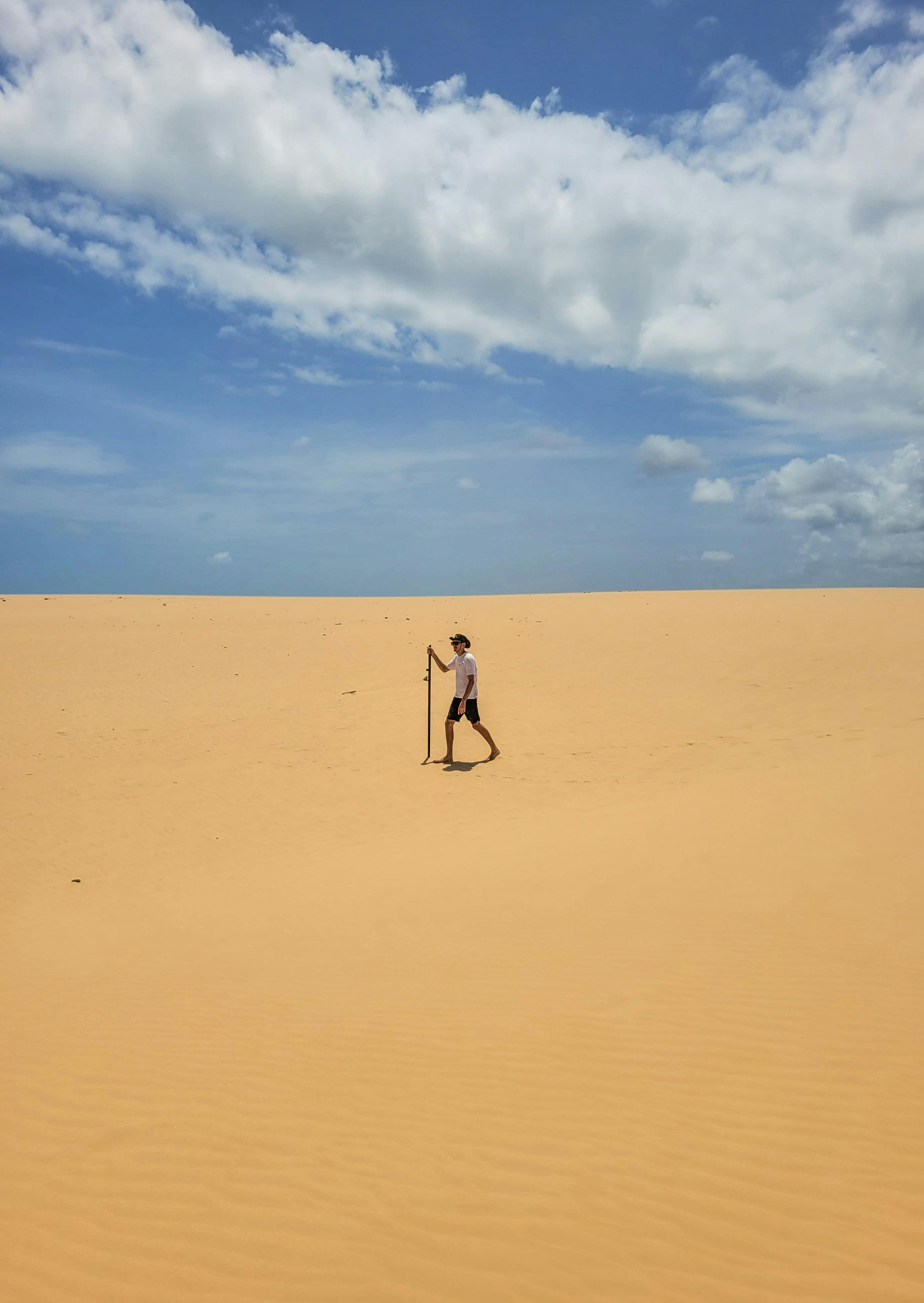 a man walking alone in a desert