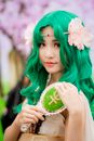 这是一幅迷人的角色扮演肖像，主角是一位绿发醒目、点缀着花卉装饰的女性