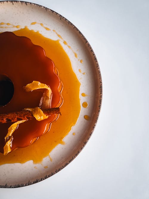 A plate with a caramel cake and orange slices