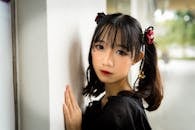 Close-Up Photo Of Girl Leaning On The Wall