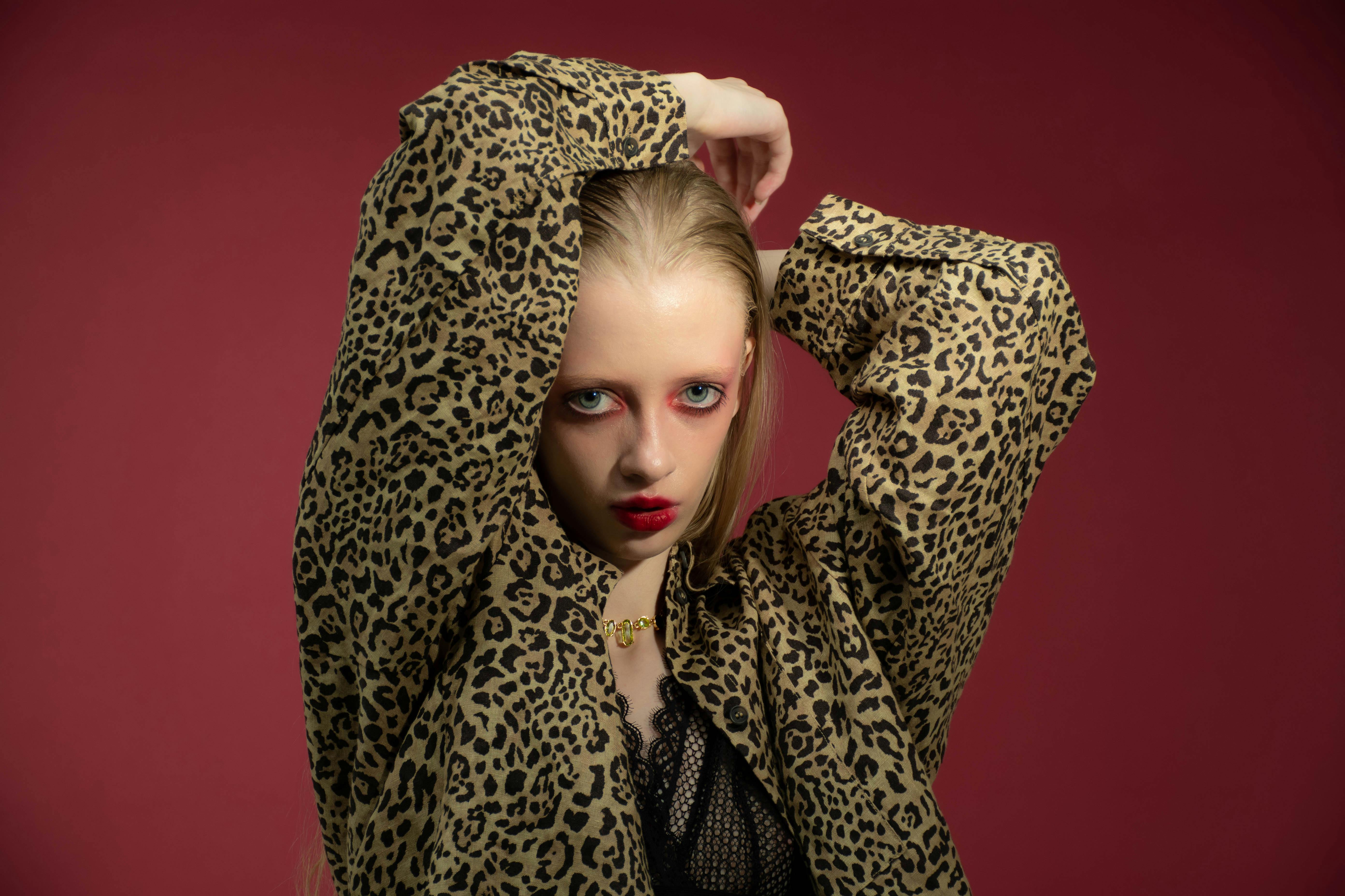 Striking studio portrait of a model in animal print with bold makeup.