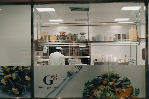 A chef cooking in a modern kitchen at night in Toyohashi, Japan.