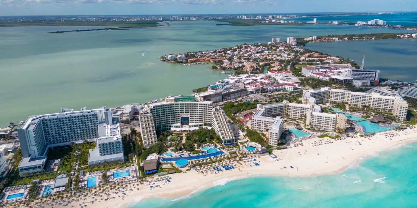 Aerial view of beachfront resorts and turquoise sea in Cancun Mexico